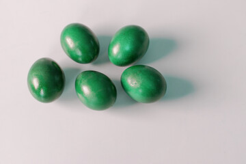 Traditional green easter eggs. Chicken eggs are painted red. High quality photo