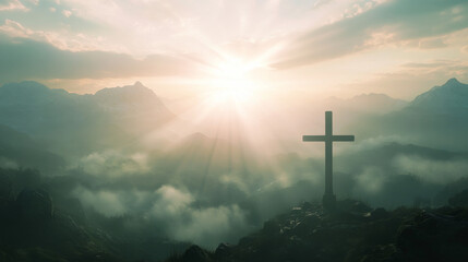 Obraz premium A large cross stands prominently on a rocky mountaintop as sunlight bursts through the clouds, illuminating the landscape below during early morning hours. The scene conveys tranquility