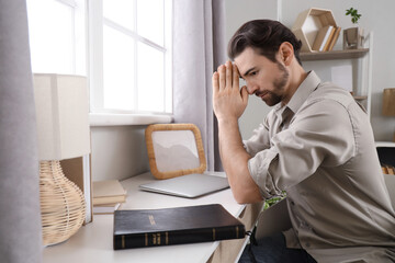 Religious man praying at  home