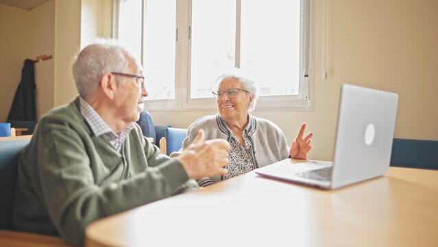 grandparent couple making a video call with a laptop computer - Powered by Adobe