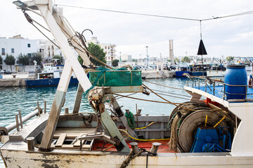 Old rusty fishing boat in Monopoli port quiet Mediterranean waters South Italy