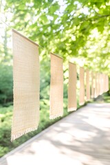 Burlap flags hanging in sunlit garden with wooden pathway