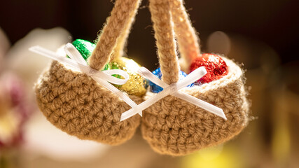 Two charming crochet baskets hold an assortment of colorful mini eggs, symbolizing creativity and the festive essence of Easter, crafted with artistry and care.