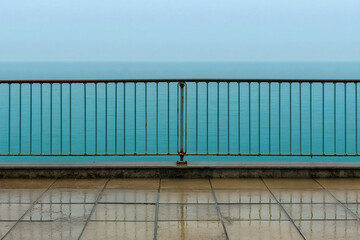 Fototapeta premium Tranquil Seaside View with Rain-Drenched Railing