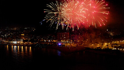 Nocturne aerial view of the fireworks launched in the beach of El Postiguet, in the Mediterranean city of Alicante, Spain.