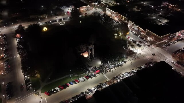 IOWA - 12.6.2024 - Beautiful aerial view circling a park lit up at night for a Christmas festival in Pella, Iowa.