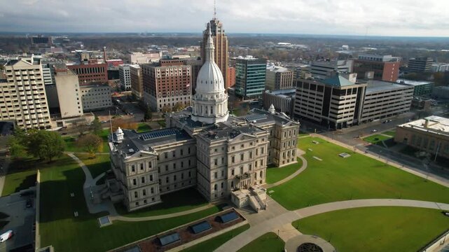 LANSING - 12.5.2024 - Wonderful aerial footage circles towards the entrance of the Michigan State Capitol.