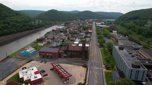 PENNSYLVANIA - 7.11.2024 - Good aerial footage moving up a busy street parallel to the Little Conemaugh River in Pennsylvania.