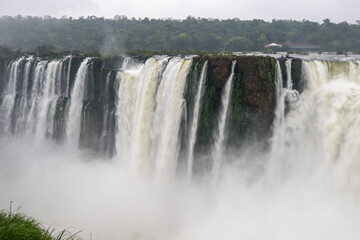 Fototapeta premium Breathtaking section of Iguazu Falls, showcasing the immense power of water as it plunges into a foggy cloud