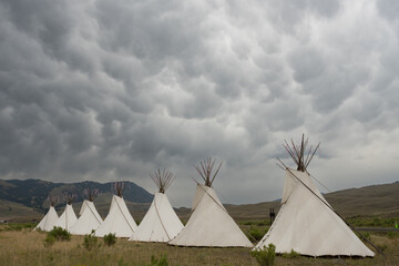 Textured Rain Clouds Build Over Seven Teepees On Display In Gardiner