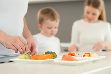 A family prepares a healthy meal with a focus on portion control, ensuring balanced nutrition for winter weight loss. Engaging children in healthy eating habits is essential.