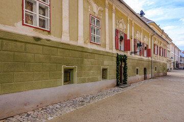 A building with a green brick wall and red trim