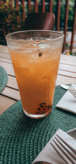 Brazilian Passion Fruit drink with a blurred green background. Tropical vibes