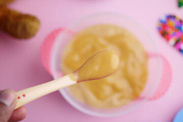 Colorful Baby Meal with Wooden Toys on Pink Background