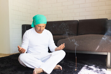 man in silence meditating at home