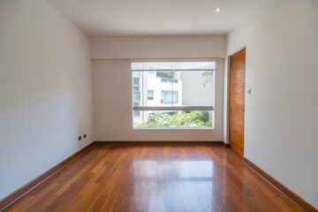 habitacion de departamento moderno con ventana y  paredes blanca, piso de melamina