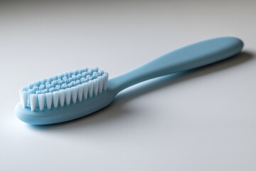 Close-Up of a Light Blue Toothbrush on a Plain Background, Showcasing Soft Bristles Ideal for Effective Oral Hygiene and Daily Dental Care Routines