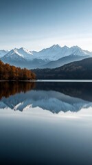 Fototapeta premium Stunning mountain reflection in a serene lake with autumn foliage.