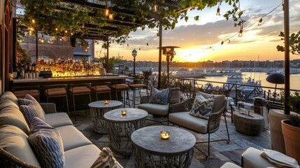 Fototapeta premium Rooftop bar overlooking a harbor, featuring nautical decor and a peaceful sunset.
