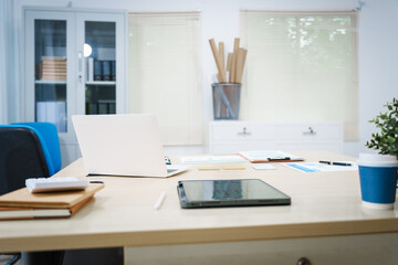 An office desk with a laptop, graphs, and documents neatly arranged. The workspace reflects a professional environment, ideal for tasks involving data analysis, reporting, and strategic planning