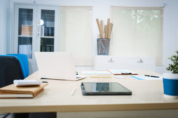 An office desk with a laptop, graphs, and documents neatly arranged. The workspace reflects a professional environment, ideal for tasks involving data analysis, reporting, and strategic planning