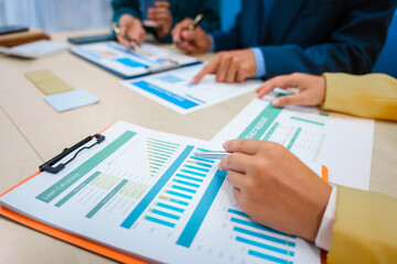 Close-up of three business people's hands during a meeting at an office table.They are engaged in discussions,planning,analyzing finance, investments, and market trends during a monthly team meeting