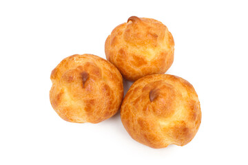 Three profiteroles on a white background. Sweet profiteroles with cream.
