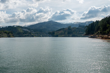 Serene mountain lake reflecting a tranquil sky.  Find your peace in nature's embrace.