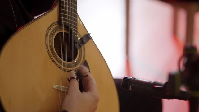 Close up of musician playing Portuguese guitar during live performance