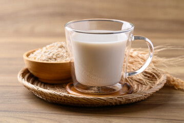Oat milk in cup glass on wooden background, Alternative milk made from plant, non dairy