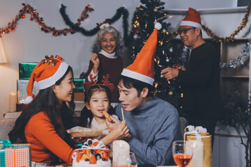 Happy family with gifts celebrating Christmas together