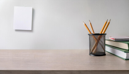 Office workspace with a clean empty desk, books, and supplies against a white background  
