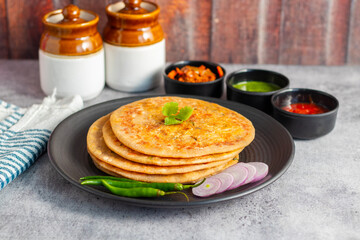 Paneer ka paratha is a delicious Indian flatbread stuffed with spiced paneer, served hot with chutney, curd, or pickle.