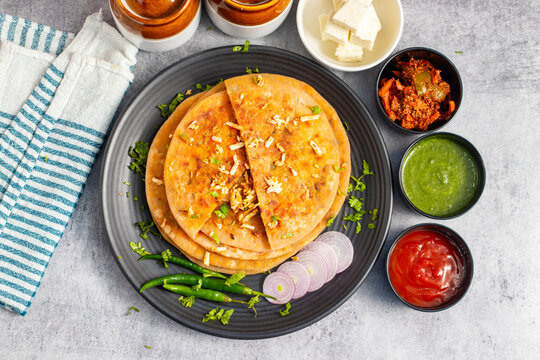 Paneer ka paratha is a delicious Indian flatbread stuffed with spiced paneer, served hot with chutney, curd, or pickle.