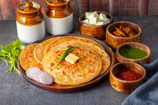 Paneer ka paratha is a delicious Indian flatbread stuffed with spiced paneer, served hot with chutney, curd, or pickle.