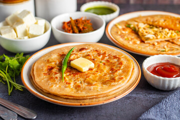 Paneer ka paratha is a delicious Indian flatbread stuffed with spiced paneer, served hot with chutney, curd, or pickle.