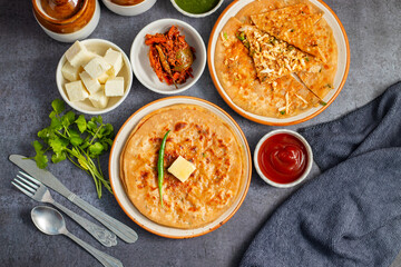 Paneer ka paratha is a delicious Indian flatbread stuffed with spiced paneer, served hot with chutney, curd, or pickle.