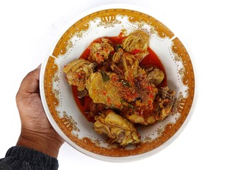 Ayam Woku, a typical chicken dish from Manado, North Sulawesi, Indonesia. Which has a rich aroma and a spicy taste. Isolated on white background.