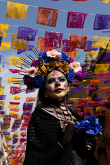 emblematic catrina of mexico with flowers and necklace in church with sempasuchil flowers in nature