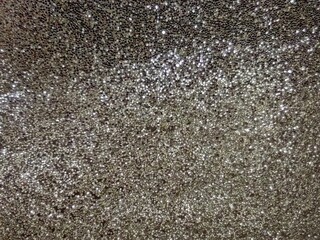 Sparkling gray crystals, lights in focus and out of focus. Wallpaper, background. 