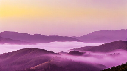 Obraz premium Sunrise paints the misty mountain landscape with vibrant hues as the sun emerges from behind distant peaks