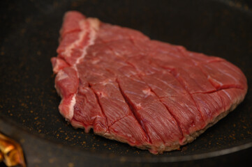 Sizzling steak cooking on a hot skillet, showcasing beautiful marbling and juicy tenderness