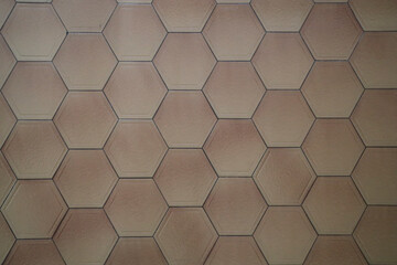 grey seams, hexagon tiles of solid beige tile marble are beautifully textured. tiled floor. top view flooring.