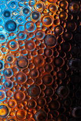 circles pattern in blue and brown tones. textured glass background. multicolored light in circles...
