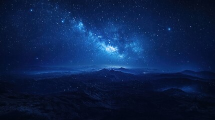 Fototapeta premium A serene night sky filled with stars and a distant galaxy over a dark mountainous landscape.