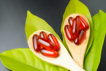 wooden spoon with soft gels, Fish oil capsules, omega 3, omega 9, vitamin D, vitamin E