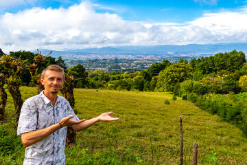 Handsome man tourist with beautiful mountain landscape panorama Costa Rica.