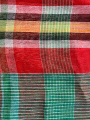 multicolored striped cotton fabric features a dynamic blend of bold checkered and linear patterns, creating a lively and modern visual appeal