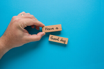 Have a good day is written on wooden blocks standing on a blue background