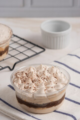 Tiramisu cake decorated with cocoa powder. Close up food. Traditional italian dessert. Perfect for recipe, article, catalogue, or any commercial purposes. with copy space.